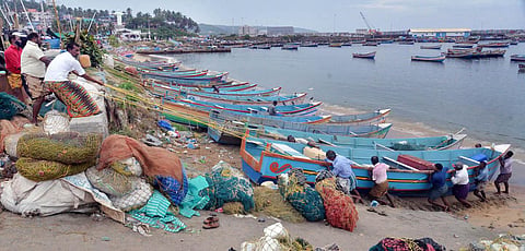 Fishermen pull their boats ashore at Vizhinjam in Thiruvananthapuram after an alert was sounded in the district owing to Cyclone Biveri. (Photo | Vincent Pulickal, EPS