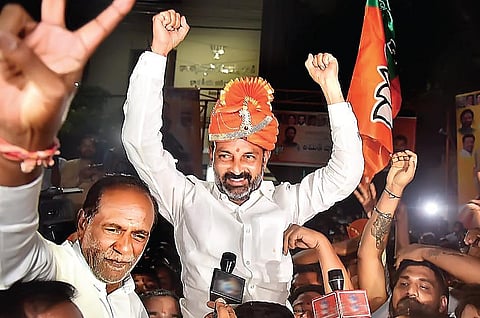 MP and BJP State unit president Bandi Sanjay Kumar, along with the party’s OBC Morcha national president K Laxman, celebrates at the party office in Hyderabad on Friday