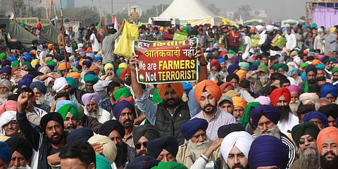Farmers hold placard during their Delhi Chalo protest march against the new farm laws at Singhu border in New Delhi on Sunday. (Photo | Shekhar Yadav, EPS)