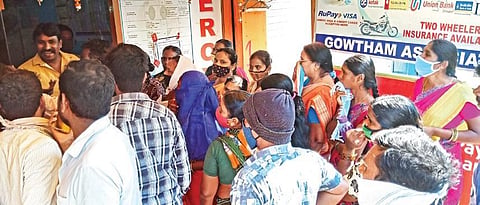 Flood victims queue up in front of a Meeseva centre for Rs 10,000 relief, at Prasanth Nagar Colonyin Hyderabad on Monday | Vinay Madapu