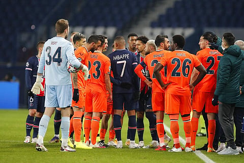 Players of Paris Saint Germain and Istanbul Basaksehir leave the pitch, after an argument between the Turkish players and the fourth referee during the Champions League match. (Photo | AP)