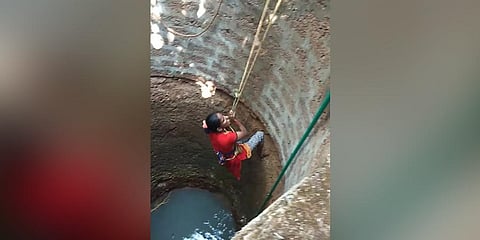 Rajani Damodar Shetty, a homemaker from Doddahithlu, rescues a dog from a 30-ft well on Thursday. (Photo| EPS)