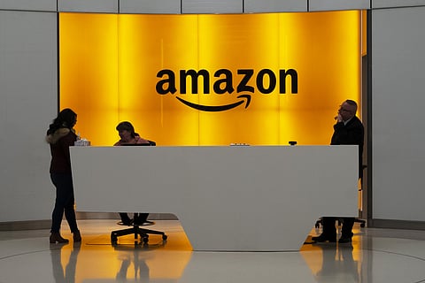People stand at the lobby for Amazon offices in New York. (Photo| AP)