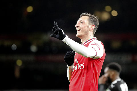 Arsenal's Mesut Ozil celebrates after scoring his side's third goal during the English Premier League soccer match between Arsenal and Newcastle at the Emirates Stadium in London, Sunday, Feb. 16, 2020. (Photo | AP)