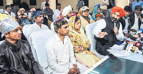 Delhi Sikh Gurdwara Management Committee president Manjinder Singh Sirsa with 10  Hindu families who have arrived from Pakistan seeking refuge. (Photo | PTI)