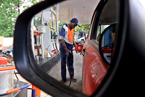 An empoyee at a petrol bunk fills fuel in a car. (Photo | Debadatta Mallick, EPS)
