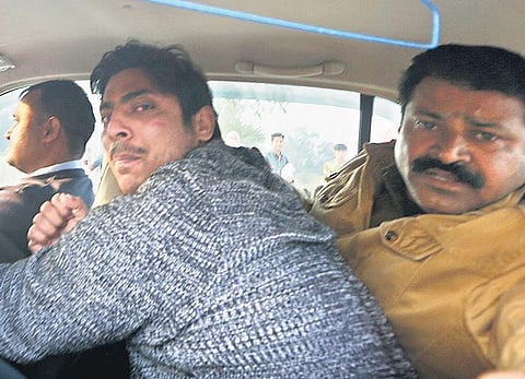 Police take away Kapil Gujjar of Dallupura, who opened fire at Shaheen Bagh area of New Delhi on Saturday | Shekhar Yadav