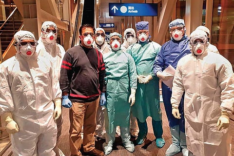 Doctors and other team members of the specially-prepped Air India’s B747 aircraft wait to receive the Indian students, stranded amid the coronavirus outbreak, at the airport in Wuhan on Saturday | PTI