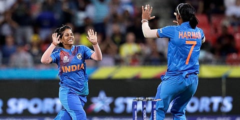 India's Poonam Yadav (L) celebrates with teammate Harmanpreet Kaur after taking the wicket of Australia's Jess Jonassen during the first game of the Women's T20 Cricket World Cup in Sydney. (Photo | AP)