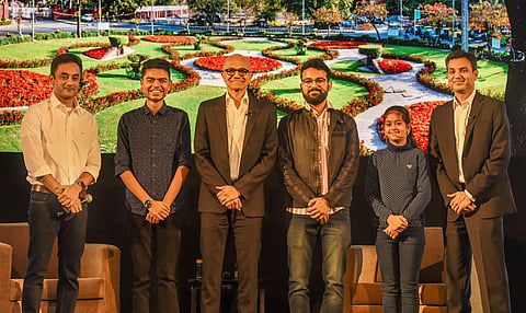 Satya Nadella (3rd left) poses for a group photo with Namya Joshi (5th left) and other students during the Young Innovators Summit in New Delhi. (Photo | PTI)