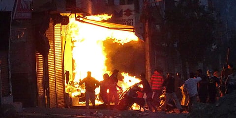 On February 25 a mob barged into Anwar's house and set it on fire after dragging him outside. (Photo | AP)