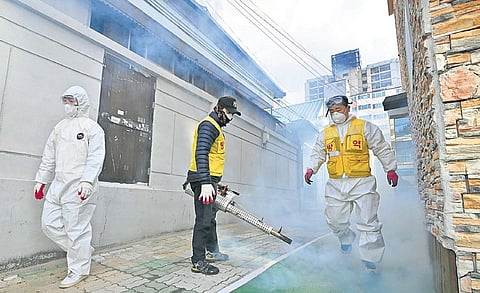 Analysts have warned that the pathogen's economic impact could reach level of 2008 financial crisis. (Photo | AFP)