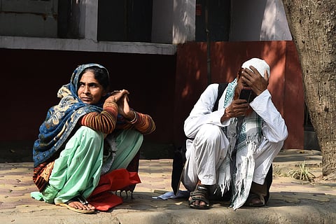 Md Ibrahim and Gulshan Khatoon, father and mother of Mubarak (35) who was killed during communal violence in northeast Delhi area outside the mortuary of GTB hospital in New Delhi on Friday. (Photo | Partveen Negi/EPS)
