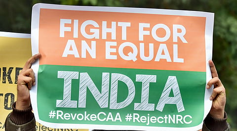 Activists hold placards during anti-Citizenship Act protest. (Photo| PTI)