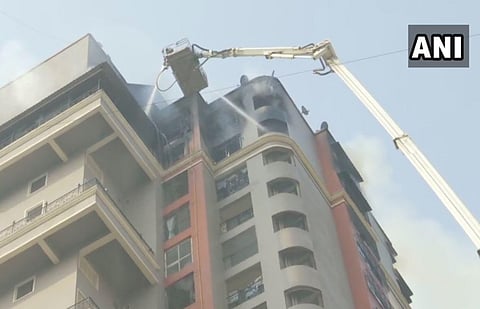 Fire fighting operation underway at high-rise apartment building at Sector 44 Nerul Seawoods. (Photo | ANI)
