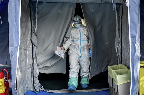Medical personnel leaves one of the emergency structures that were set up to ease procedures. (Photo | AP)