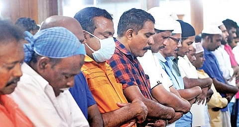Amid the COVID-19 scare, a believer wearing a face-mask takes part in the Friday namaz at the Juma Masjid in Kaloor  |  A Sanesh
