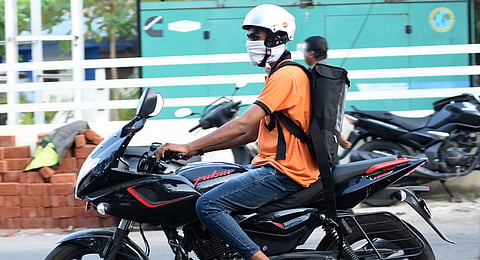 A Swiggy delivery boy wears a mask on his way  to deliver food. (Photo | B P Deepu, EPS)