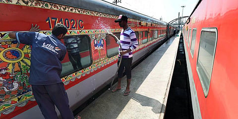 Railway workers disinfect a coach of a train at Rajendranagar Yard in Patna. 