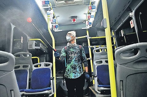 A worker sanitising Mo Bus in Bhubaneswar. (Photo | Biswanath Swain, EPS)