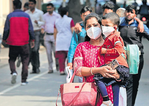 A mother and child wearing protective masks in the wake of COVID-19 outbreak, at Safdarjung Hospital on Wednesday | Shekhar Yadav