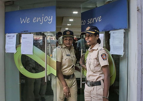 Mumbai Police personnel stand guard outside Punjab and Maharashtra Cooperative Bank PMC at GTB Nagar in Mumbai. (File | PTI)