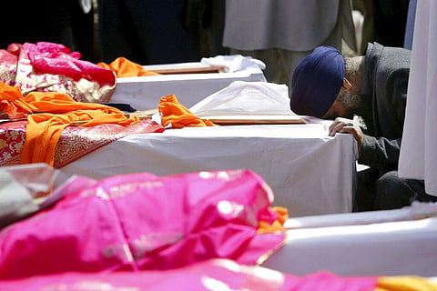 Afghan Sikh man mourns over a coffin during a funeral procession and cremation ceremony for those who were killed by IS terrorist attack inside a Gurudwara in Kabul, Afghanistan, Thursday, March 26, 2020. (Photo | AP)