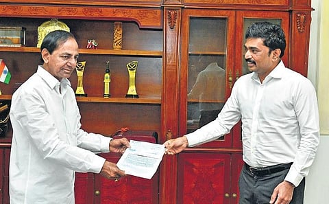 MEIL MD PV Krishna Reddy hands over a cheque of `5 crore to Telangana CM  K Chandrasekhar Rao at Pragathi Bhavan in Hyderabad on Thursday