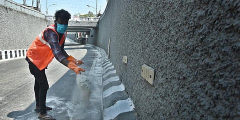 A Chennai Corporation worker seen sanitising the road at Pazhavanthaangal subway.  (Photo | Ashwin Prasath, EPS)