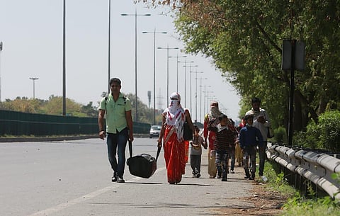 Migrant daily wage laborers make the journey to their respective villages on foot following a lockdown amid concern over spread of coronavirus in Dharuhera, Haryana on Saturday. (Photo | Shekhar Yadav/EPS)