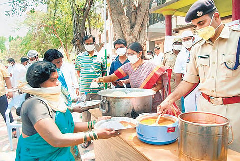 Medak District Judge K Sai Rama Devi serves food at the court premises at Sangareddy.