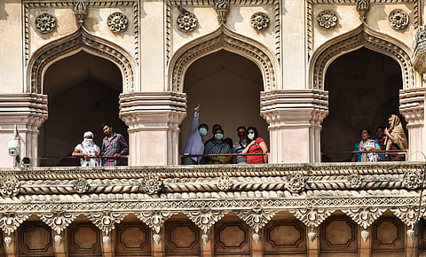 Tourists wear masks as they visit Charminar in  Hyderabad on Wednesday (Photo | Vinay Madapu, EPS)
