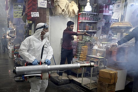 A firefighter disinfects a traditional shopping center to help prevent the spread of the new coronavirus in northern Tehran, Iran. (Photo | AFP)