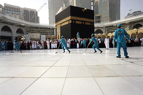 Workers sterilize the ground in front of the Kaaba, the cubic building at the Grand Mosque, in the Muslim holy city of Mecca, Saudi Arabia, Thursday, March 5, 2020. (Photo | AP)