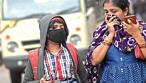 A school student and her mother covering their faces for protection against coronavirus in Bhubaneswar on Friday | Biswanath Swain