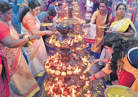 Devotees lighting the lemon lamp at Attukal Bhagavathy Temple on Saturday