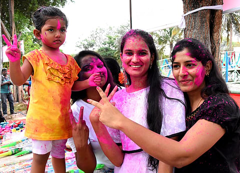 Students enjoying Holy in advance in urbanot near Tirupati on Sunday. (Photo | Madhav K/EPS)