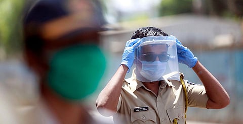 A police personnel wears plastic sheet on face while on duty during the nationwide lockdown. (Photo| ANI)