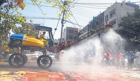 A Japanese spray machine sprays disinfectant during a sanitisation drive in New Rajendra Nagar on Monday. (Photo | EPS/Anil shakya)