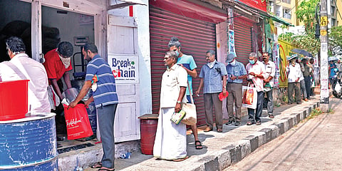 Beneficiaries standing in front of the ration shop for getting their free ration, by adhering to social distancing norms, at Nanthankode in  Thiruvananthapuram. (File Photo | EPS)
