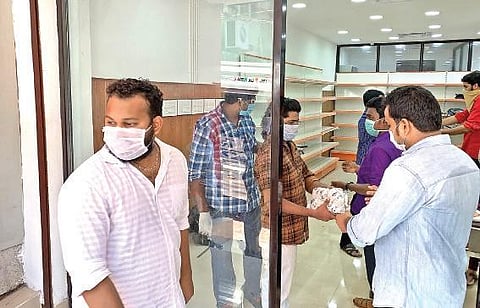 Meals parcels being handed over to customers at the Janakeeya Hotel near SMV School, Overbridge  junction