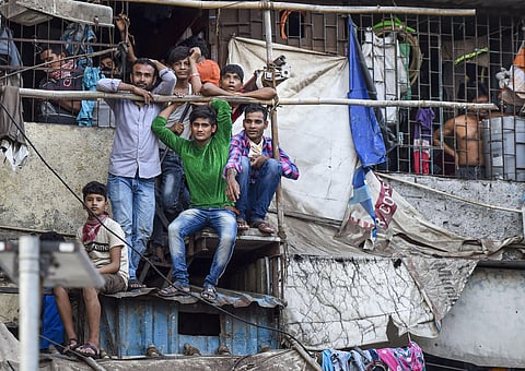 Families of workers look from their houses after the extension of lockdown till May 3 in the wake of coronavirus pandemic outside Bandra Railway Station in Mumbai Tuesday April 14 2020. (Photo | PTI)