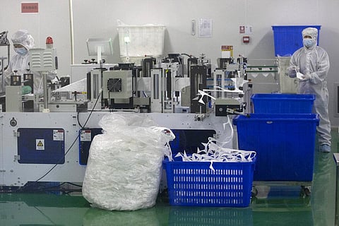 In this Sunday, April 12, 2020, photo, workers are seen at a production line for masks at the Wuhan Zonsen Medical Products Co. Ltd. in Wuhan in central China's Hubei province. (Photo | AP)