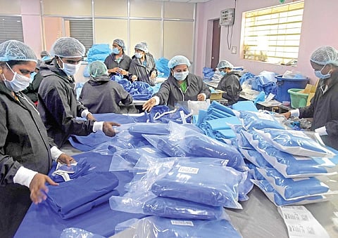 Diamond Medicare workers making PPE kits in Vijayawada. (Photo | EPS/I P RAVINDRA BABU)