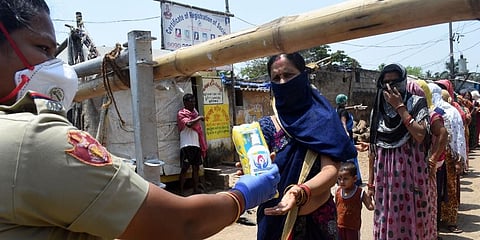 Sanitary napkins being distributed by Commisionrate Police at containment zone of Surya Nagar in Bhubaneswar. (Photo | Biswanath Swain, EPS)