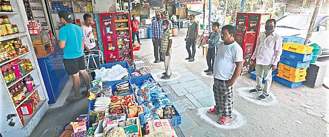 Customers practise social distancing while purchasing essentials at a shop. (File Photo | EPS/ Shekhar Yadav)