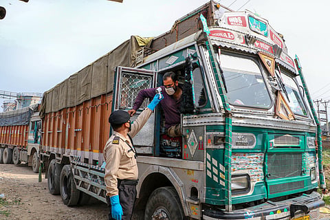 A private security personnel checks the temperature of a truck driver arriving at Food Corporation of India FCI godown during the nationwide lockdown imposed to contain the spread of coronavirus in Jammu Thursday April 16 2020. (Photo | PTI)