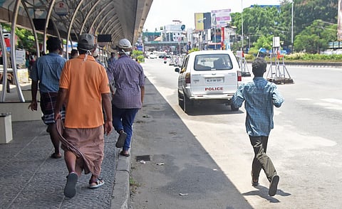Migrant and native labourers at East Fort in Thiruvananthapuram on Sunday who lost job due to lockdown chasing a police vehicle that was supplying food for the needy. Seeing the large crowd the vehicle did not stop there and the workers continued their wa