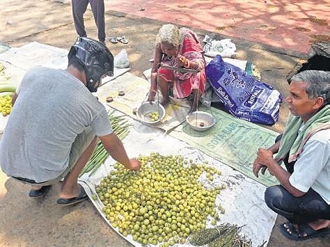 People buying amla from Rasa Dei in Dhenkanal town. (Photo | EPS)