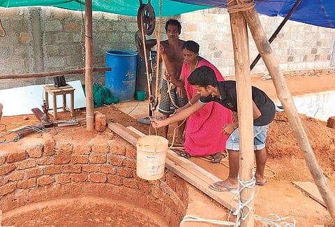 Nedumbassery native Alias A M with wife Lissy and younger son Bibin at the well near their new house. The well was dug up by Alias during the lockdown in just 17 days  | Express